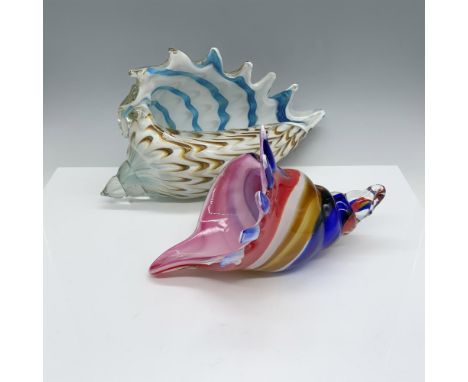 Duo of home decor that includes a larger white seashell with yellow and blue waves and a smaller multicolored shell. Largest 