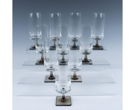 This German glass set features elongated drinking glasses with smokey square bases. R mark etched. Issued: 1963 - 1982Dimensi