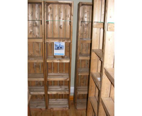 A similar five shelf display unit with plate glass shelf to the top