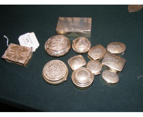 A silver snuff box together with pill boxes etc.