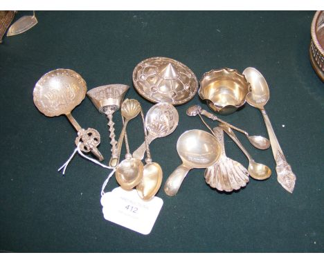 A decorative silver shield shaped brooch, caddy spoons etc.