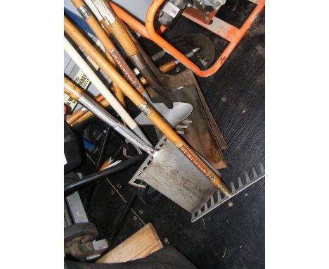 A selection of garden tools including spades, forks and rakes, together with a Workmate