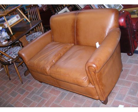 A two seater brown leather style sofa - length 130cm 