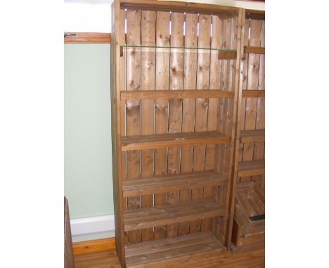 A pine shop display shelf with four wooden shelves and one plate glass shelf