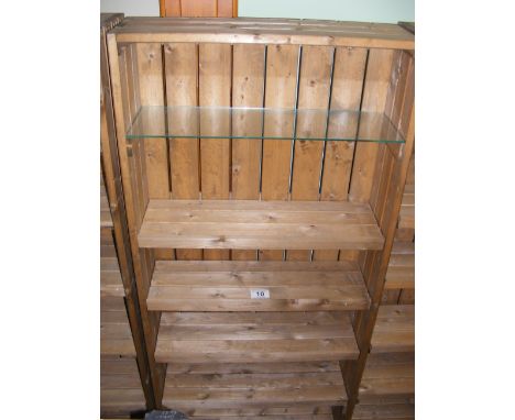 A pine shop display stand with four wooden and one plate glass shelf