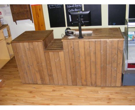 A shop check-out counter with integrated screen, scales and cash drawer
