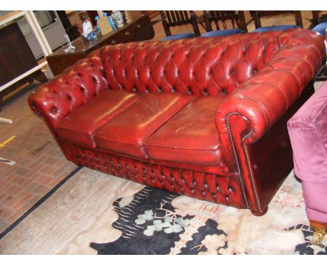 A button back chesterfield sofa in red leather
