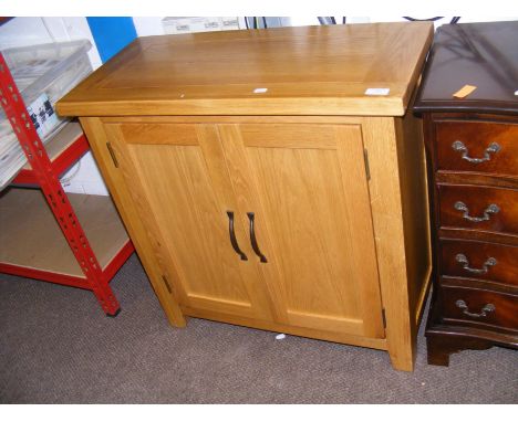 A contemporary light oak two door hall cupboard - width 75cm  