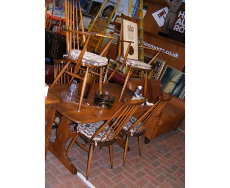 A vintage mid century Ercol dining table with six Ercol Goldsmith's dining chairs 