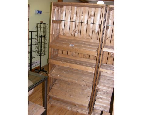 A similar pine shop display shelf with four canted wooden shelves and one plate glass shelf