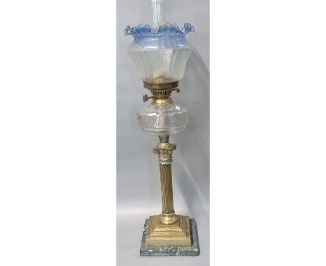 Early 20th century double oil burner lamp having blue frilled and frosted etched glass shade above clear glass reservoir on a