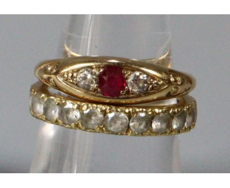 18ct gold three stone ruby and diamond ring.  4.6g approx.  Size O, together with a yellow metal eternity ring.  3.7 g approx