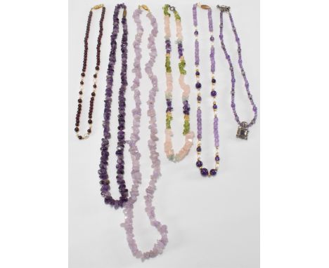 A collection of beaded necklaces to include two amethyst nugget necklaces, a multi quartz nugget necklace, and a amethyst and