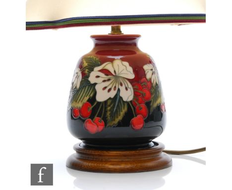 A boxed Moorcroft Pottery lamp base decorated in the Cherry Blossom pattern designed by Nicola Slaney, marks obscured by affi