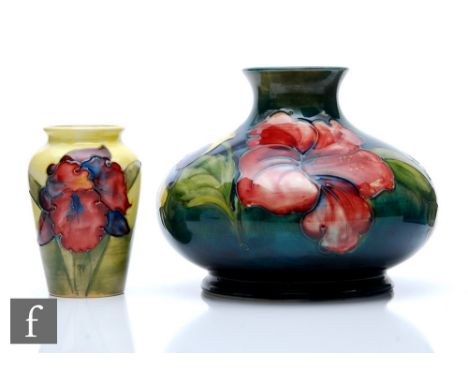 Two Moorcroft Pottery vases, the first decorated in the Hibiscus pattern against a green wash ground, height 12.5cm, the seco