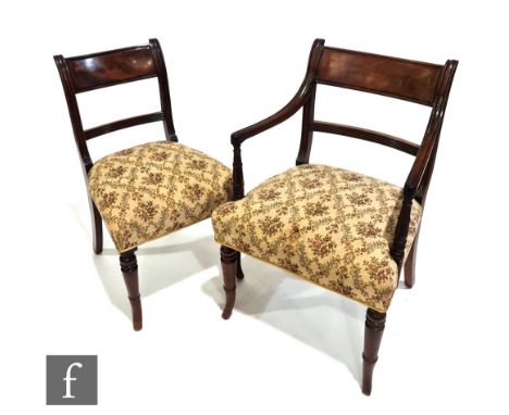 A set of eight George IV mahogany bar back dining chairs, the moulded and ring turned arms over splayed legs to the front and