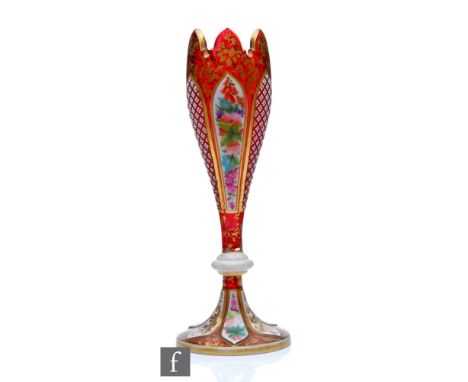 A 19th Century Bohemian ruby glass vase in the manner of Moser or Neuwelt, the tulip form with knopped stem and circular spla