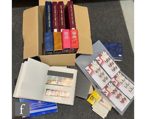 A quantity of Queen Elizabeth II first day covers in albums, together with a collection of commemorative and definitive posta