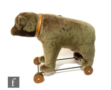A Steiff 400384 Bear on Wheels 1921 Replica, brown mohair bear on metal frame, with wooden wheels, pull cord voice mechanism,