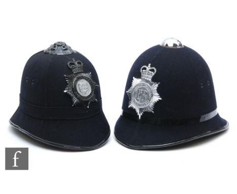 A West Mercia Constabulary blue cloth sectional helmet, height 22cm, and a later Bedfordshire Constabulary blue cloth helmet,