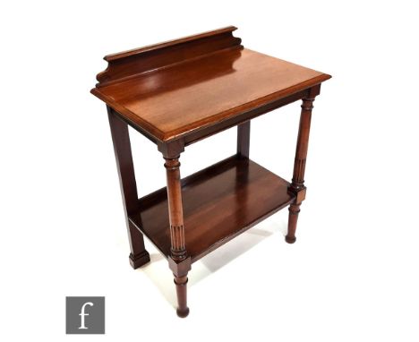 A late Victorian small two tier mahogany buffet or side table, the scroll ledge back over a moulded edge top on turned and pa