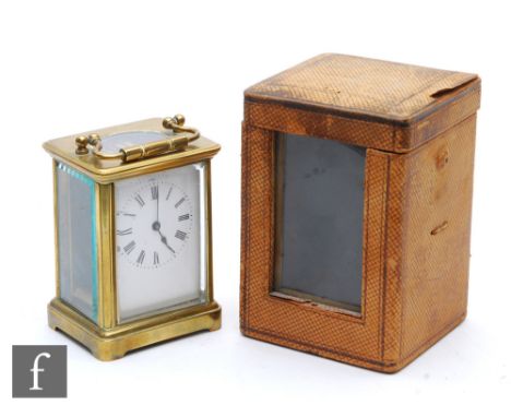 A 19th Century French brass carriage clock, white enamelled dial, in leather carrying case, height 12.5cm. 