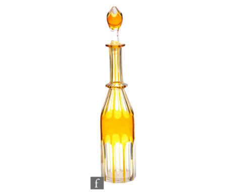 A late 19th to early 20th Century bottle form decanter, amber cased and flash cut with a slice cut base and shoulder with fac