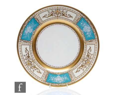 A late 19th to early 20th Century Minton plate decorated to the border with alternate gilt sprays against a cream ground and 