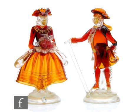 A pair of mid 20th Century Italian Venetian Murano glass figures of a couple in period dress in ruby, gold and clear crystal 