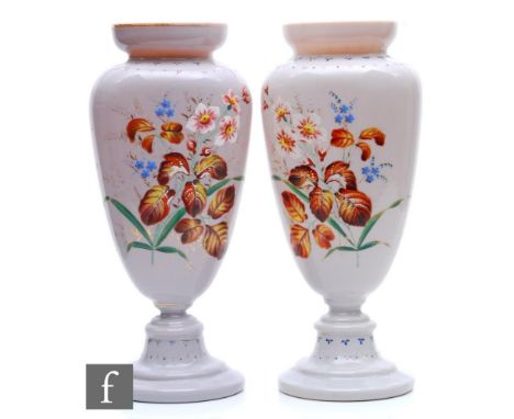 A large pair of 19th Century French pink opal glass vases of compressed ovoid form with pedestal base, each hand enamelled wi