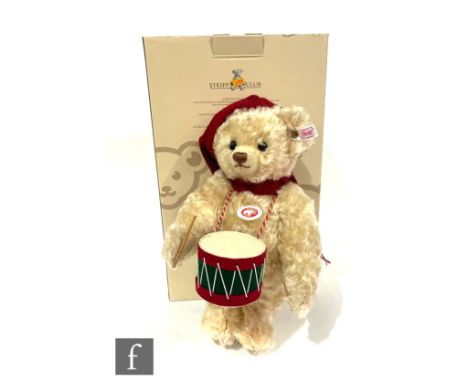 A boxed Steiff 'The Little Drummer Boy' Christmas teddy bear, cream mohair with musical key wound movement playing The Little