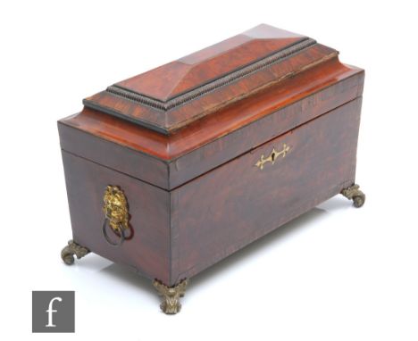 A 19th Century rosewood crossbanded mahogany tea caddy or sarcophagal form, gilt lion mask mounts on scroll feet, width 38cm,