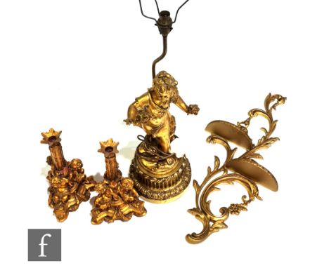 A 20th Century French composite gilt bedside lamp modelled as a young girl holding a bunch of flowers, with shade, height 88c