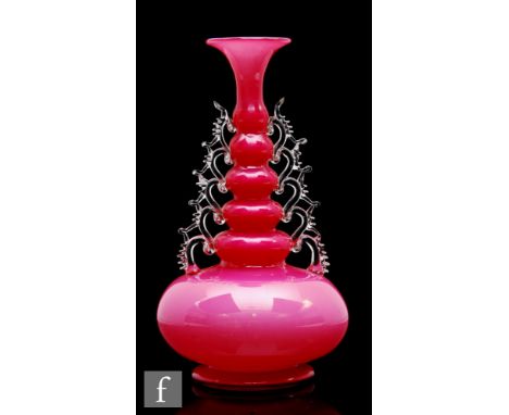 A late 19th to early 20th Century glass vase, of squat ovoid form with ribbed neck, the body internally decorated in opal and