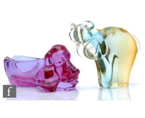 A later 20th Century Italian Murano glass figure of a stylised elephant with trunk raised, in tonal citron to pale blue and c