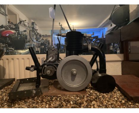 An Enfield enginenumbered 12184, mounted on wooden base; condition and completeness unknown, close inspection advised.  Lot t