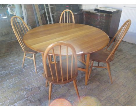 An Ercol drop leaf dining table 140cm x 127cm - with four matching chairs 