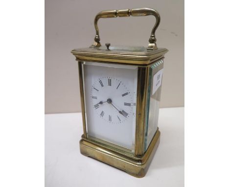 A good quality brass carriage clock striking on a gong - working in saleroom - Height 19cm 