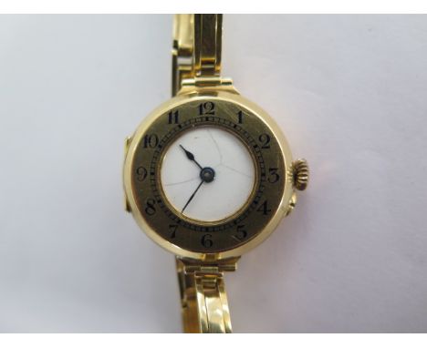 An 18ct yellow gold manual wind ladies wristwatch on 18ct sprung strap - running - approx weight 27.3 grams - dial cracked ot