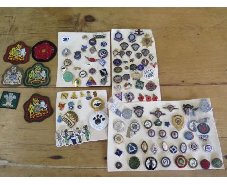 A collection of British Legion and Church badges, medals and others along with a Queen Mary enamel ships wheel badge and a ca