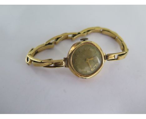 An 18ct yellow gold manual wind ladies wristwatch on 18ct sprung strap - running - approx weight 21 grams 