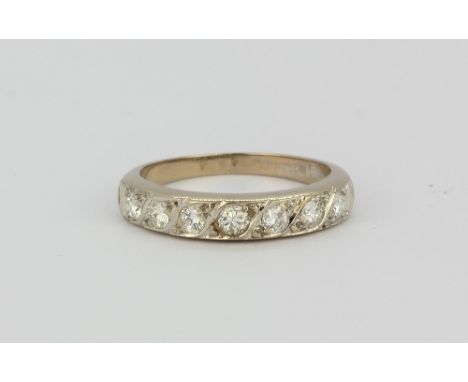 An 18ct white gold diamond set half eternity ring approx. 0.70ct, (K).