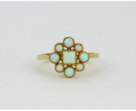 A 9ct yellow gold opal set cluster ring, (N.5).