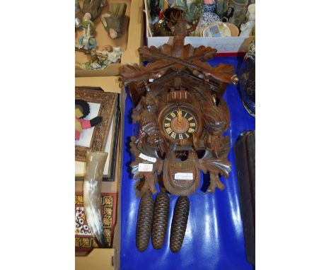 CUCKOO CLOCK MODELLED IN TYPICAL FASHION, THE CLOCK FLANKED BY DEAD GAME WITH A DEER'S HEAD ABOVE