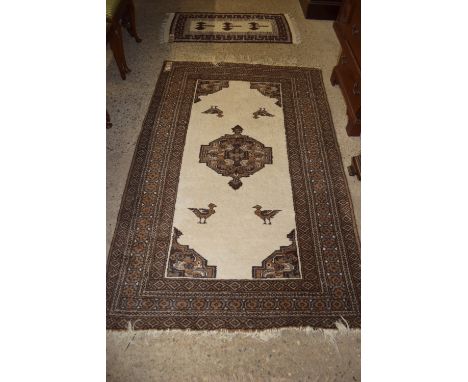 PATTERNED RUG AROUND CENTRAL PANEL CONTAINING STYLISED BIRDS ETC, APPROX 133 X 212CM