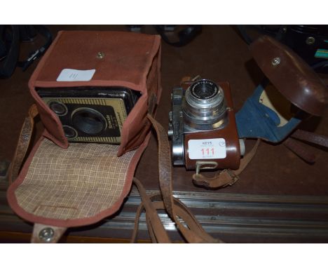 TWO VINTAGE CAMERAS: A CASED BROWNIE 6-20 MODEL D BY KODAK AND A CASED EXAMPLE