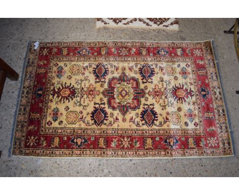 RUG WITH STYLISED FLORAL AND LEAF DESIGNS AROUND GEOMETRIC CENTRAL PANEL, APPROX 90CM X 150CM