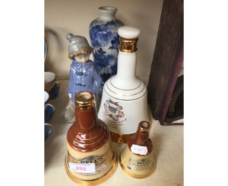 THREE WHISKY DECANTERS, NAO FIGURE AND BLUE VASE