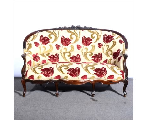 A Victorian rosewood framed sofa, contemporary Tulip pattern upholstery, carved and moulded cresting, shaped arms and legs, w