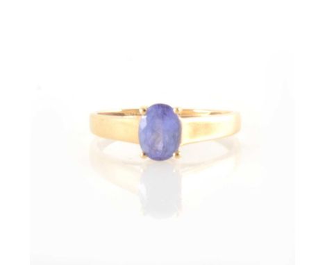 A tanzanite single stone ring, the oval mixed cut tanzanite 7.5mm x 6.6mm, four claw set in a 14 carat yellow gold mount, app